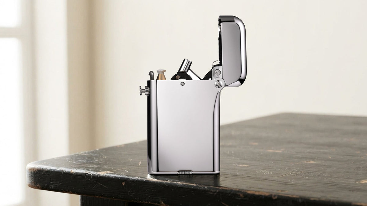 Open polished silver lighter displayed on a dark tabletop
