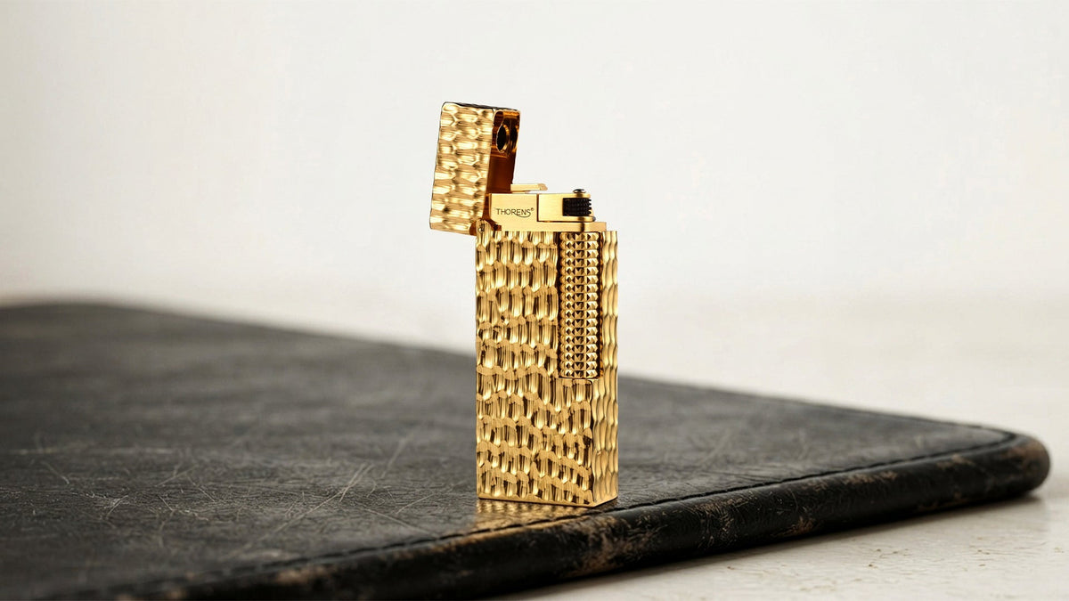 Open gold lighter with a textured rectangular case