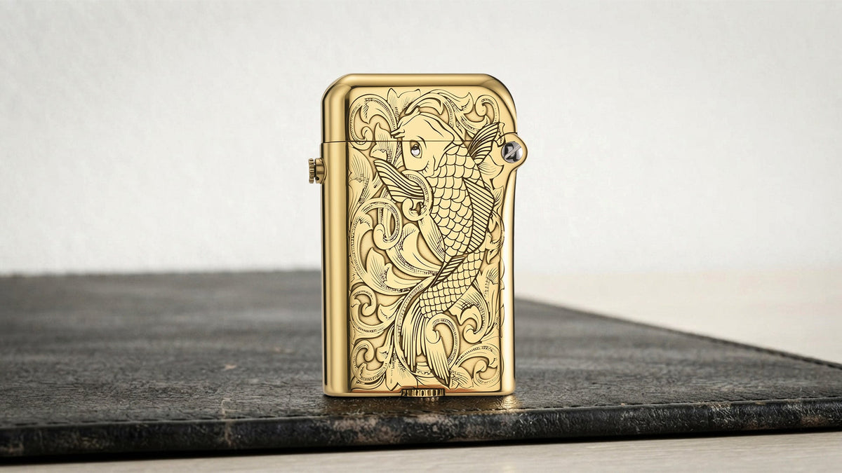 Gold lighter with engraved case displayed on a dark tabletop
