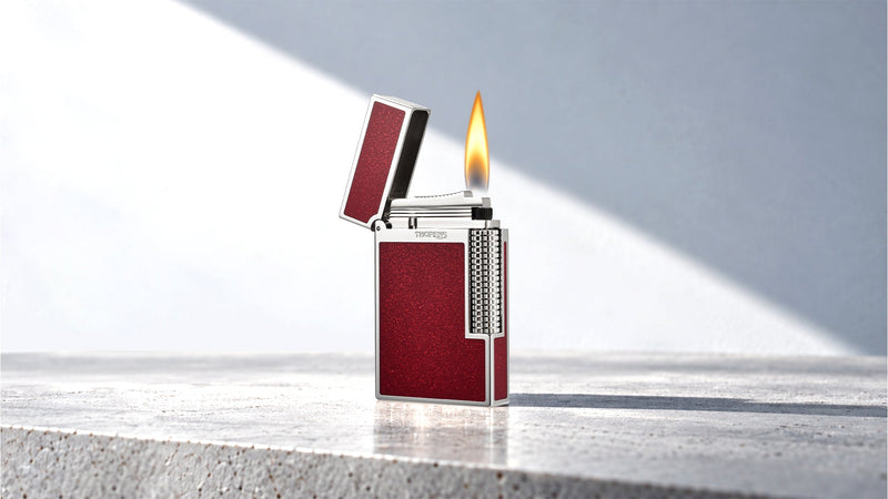 Lit red and silver lighter with an open lid