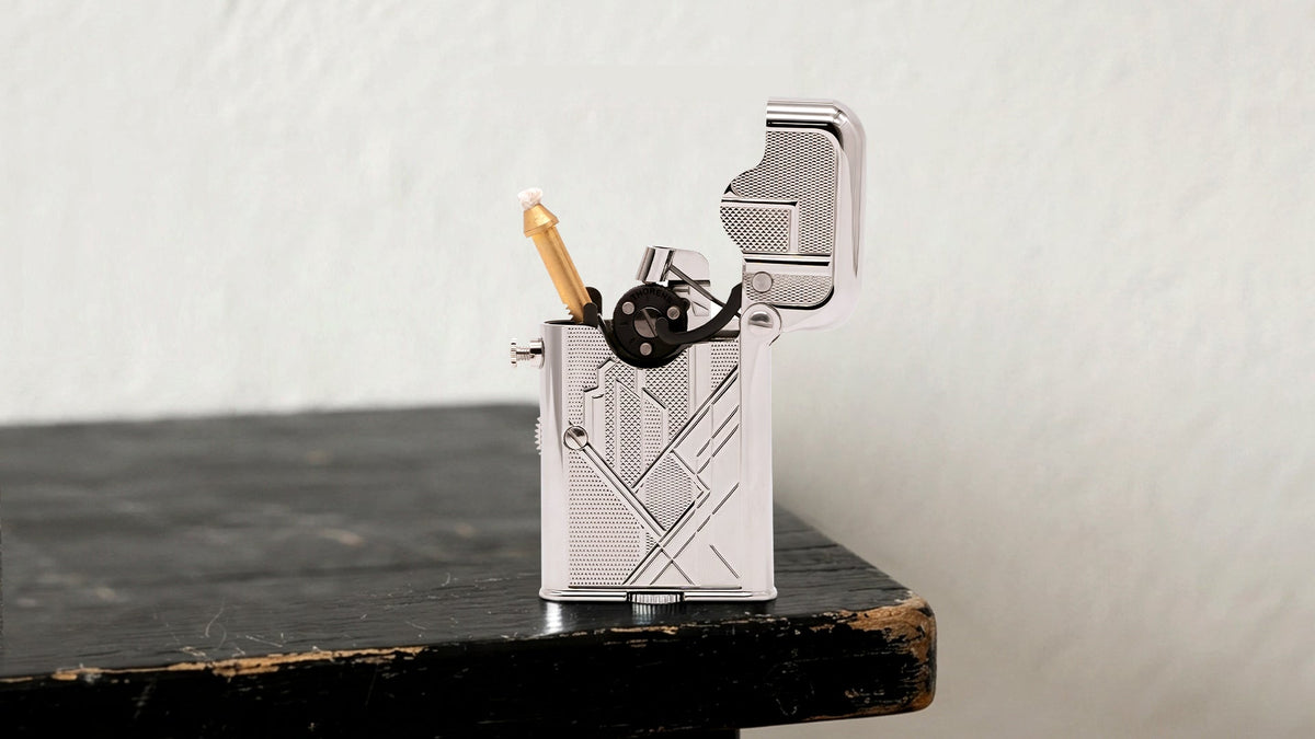 Open silver mechanical lighter showing its ignition parts