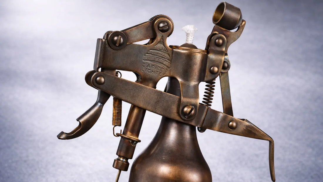 Mechanical brass table lighter with exposed fluid system and articulated metal structure