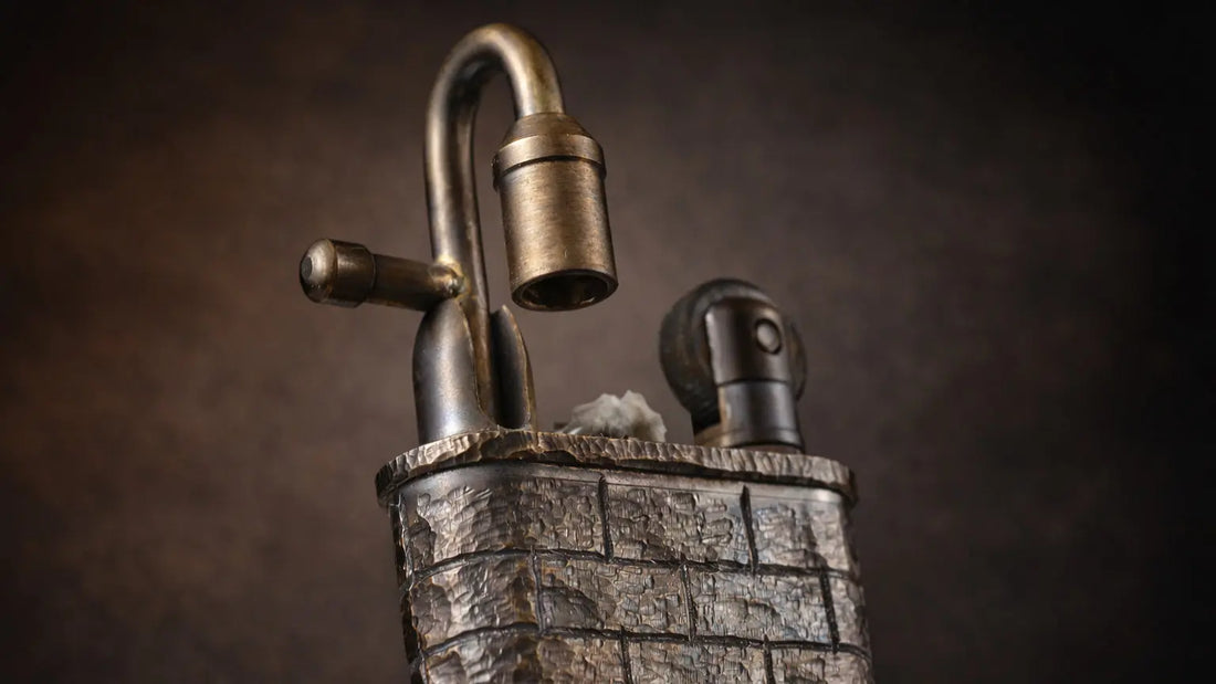Hand-carved brick wall lighter with textured metal surface, curved lock-style detail, and mechanical fluid ignition design