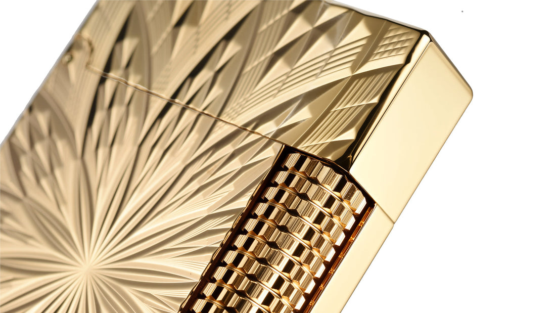 Engraved gold lighter with radiating brass pattern and high-gloss polished surface