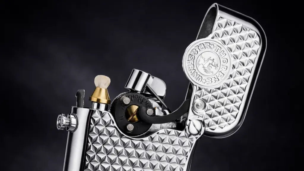 Silver mechanical fluid lighter with single-claw ignition and diamond grid texture