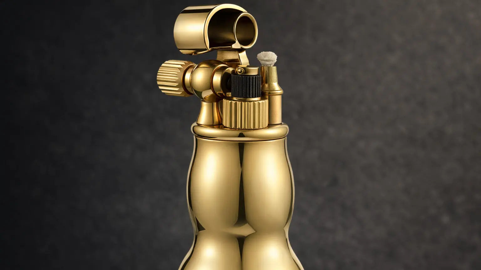 Close-up detail of a mini gourd-shaped fluid lighter showing the mechanical ignition and polished metal finish
