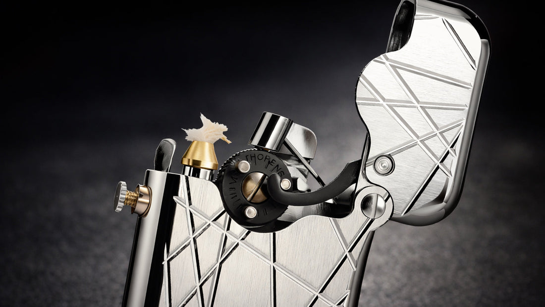 Modern grid silver mechanical fluid lighter with engraved diagonal lines and exposed ignition mechanism