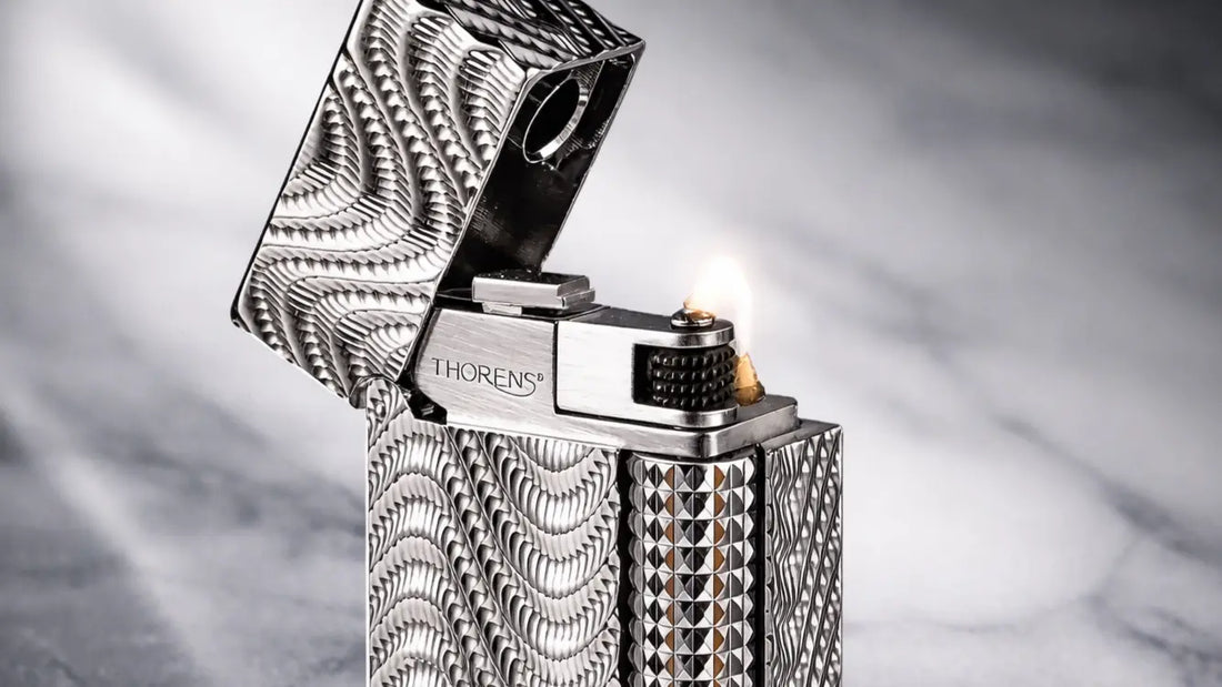 alt="Close-up detail of the Side Slip Narrow lighter Argent Mirage, featuring engraved silver metal body and side-slide ignition"