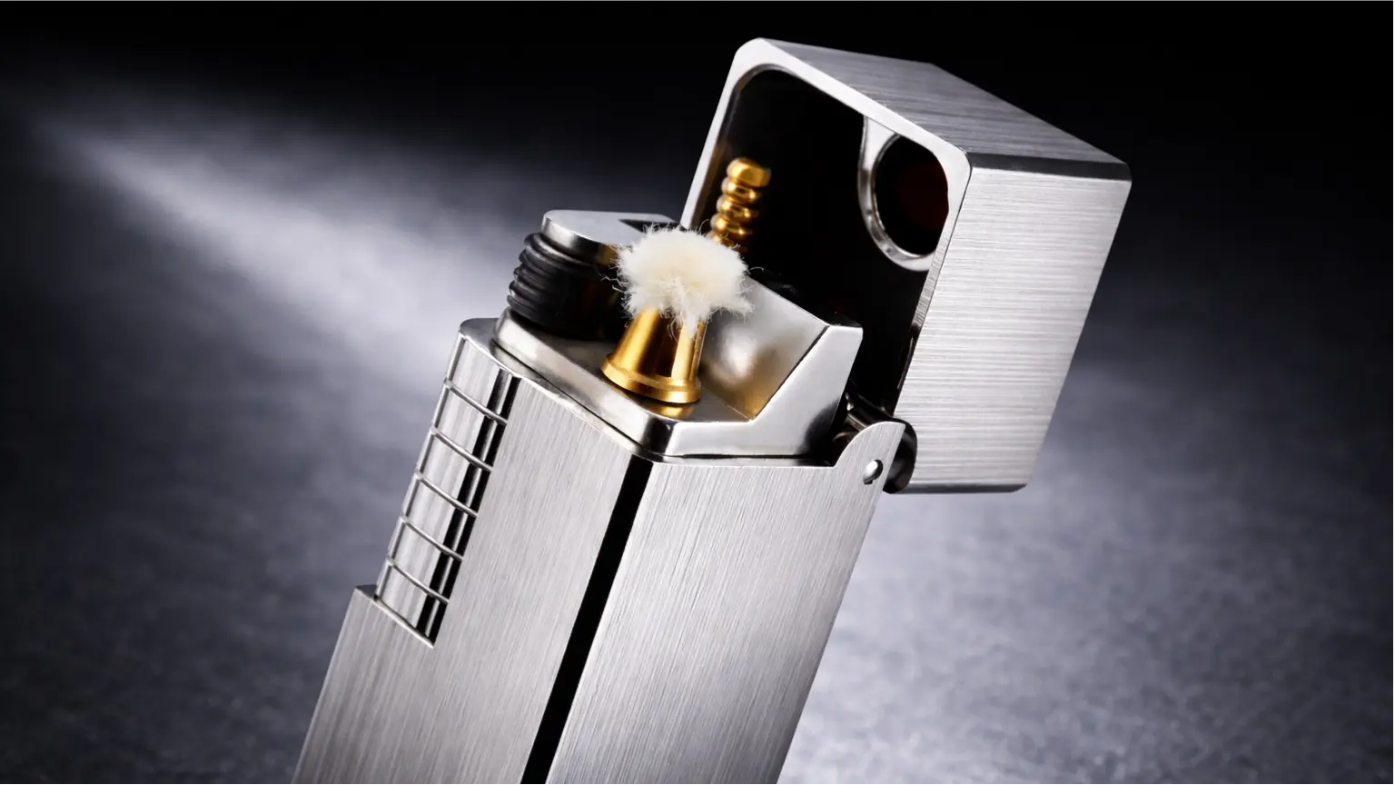 Close-up of a side slip rectangular lighter showing the ignition mechanism and brushed metal finish
