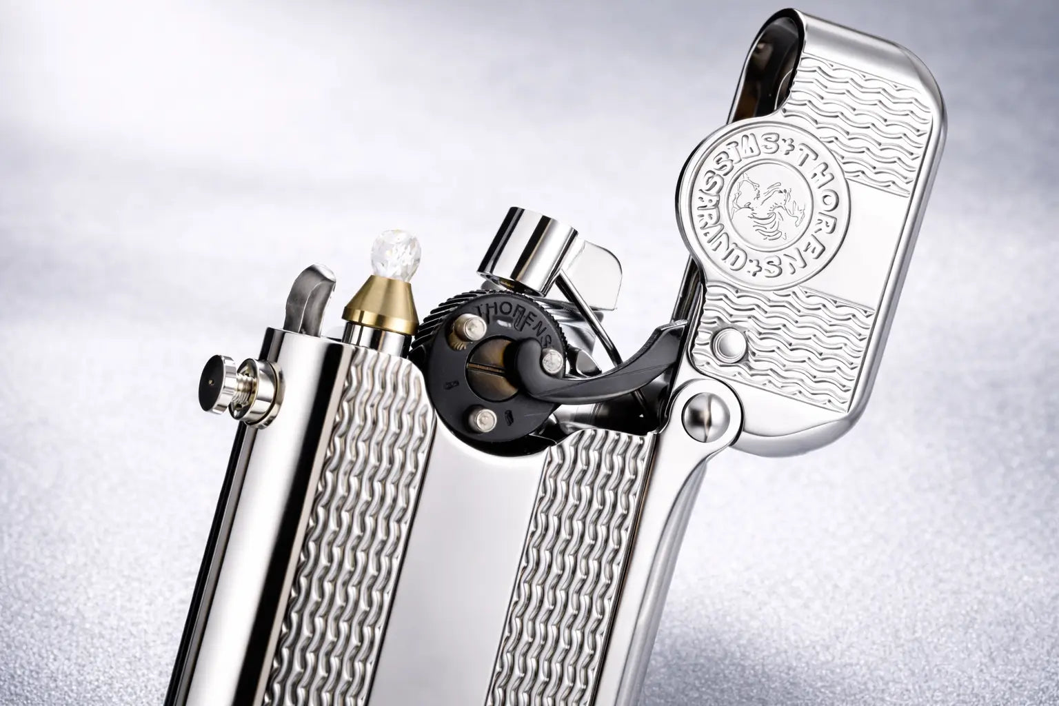 Single claw lighter with polished silver finish and wave-pattern engraving by THORENS