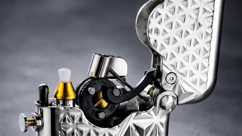 Upper mechanism detail of a single claw mechanical fluid lighter with diamond pattern silver body