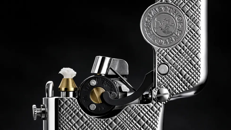 Close-up of a Single Claw Plum Pattern Silver Lighter showing the engraved brass texture and mechanical ignition detail