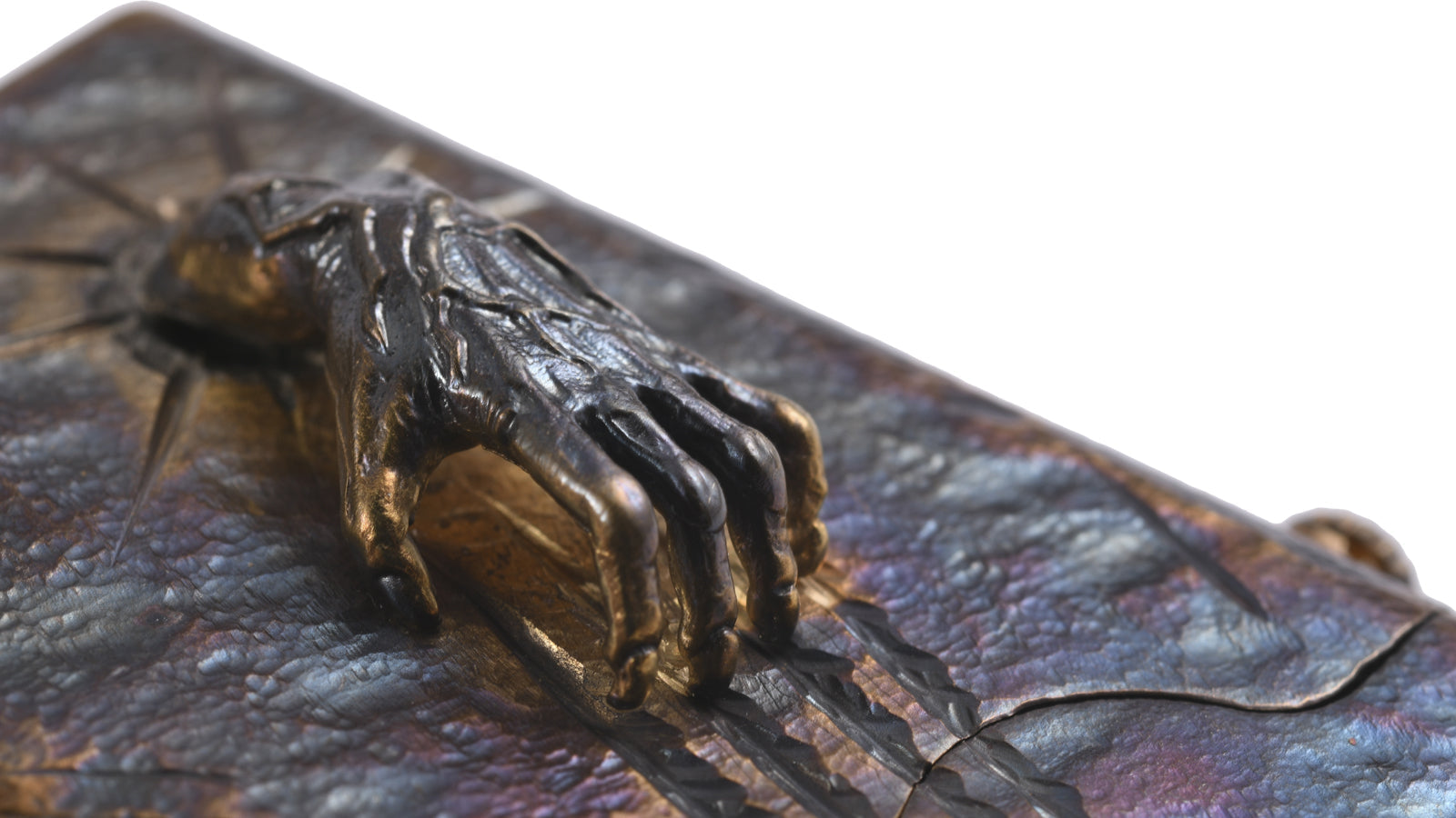 High-relief Spirit Claw sculpture detail on an oxidized metal single claw fluid lighter