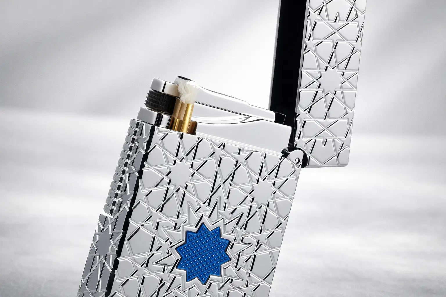 Refillable fluid lighter with engraved geometric metal design from the Stellar Mesh series