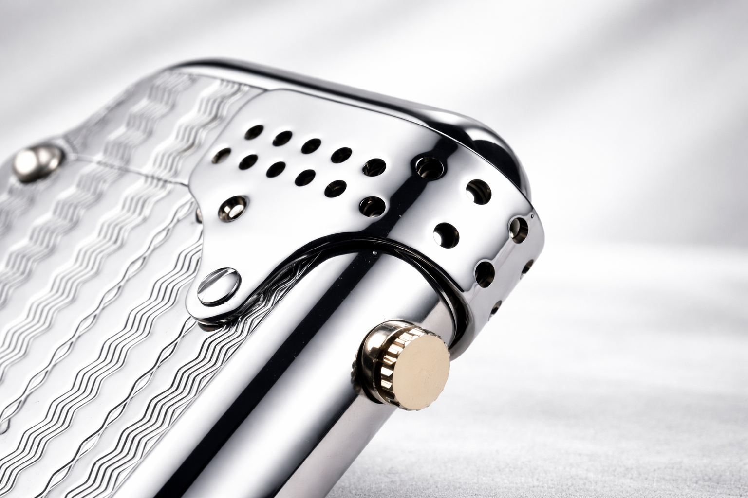 Close-up detail of a Storm Wave double claw lighter with engraved wave surface and windproof shield