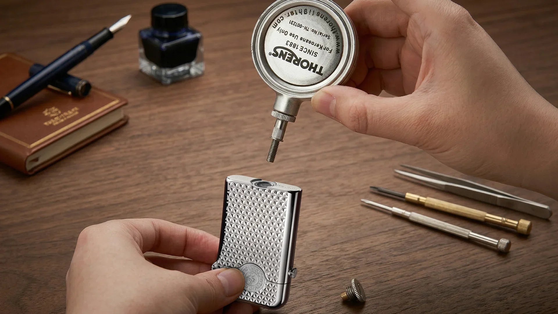 THORENS fluid lighter refill point guide showing a hand holding the lighter, removed refill screw, and fluid canister during refilling on a wooden desk.