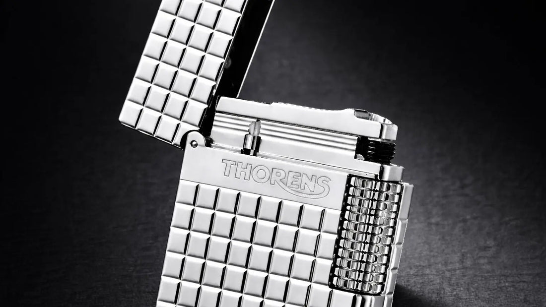 Detail view of the THORENS Side Slip Crisp Sound Lighter in silver, featuring a sculpted square block brass body and side-slip opening mechanism