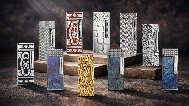 Collection shot of the THORENS Side Slip Narrow Series lighters, featuring multiple slim Swiss-made lighters displayed on stone platforms, including engraved silver models, colored panel designs, and a gold-tone style.