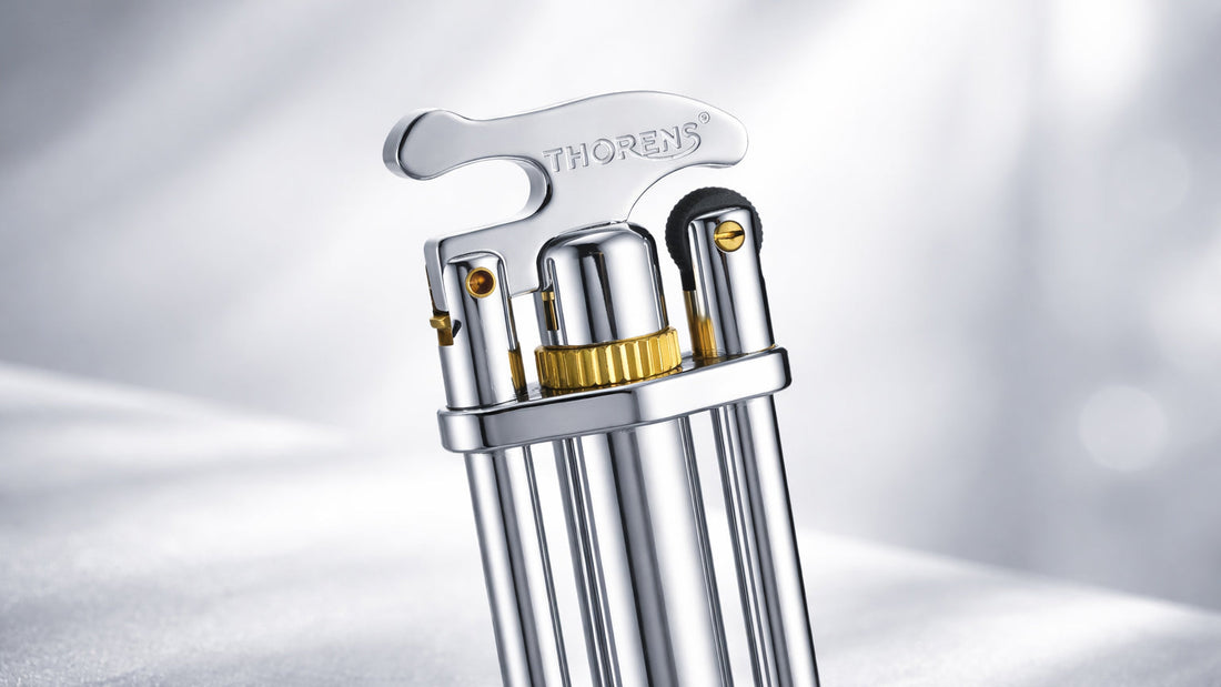 Three-section chrome stick lighter with triple-column support structure and polished mechanical finish