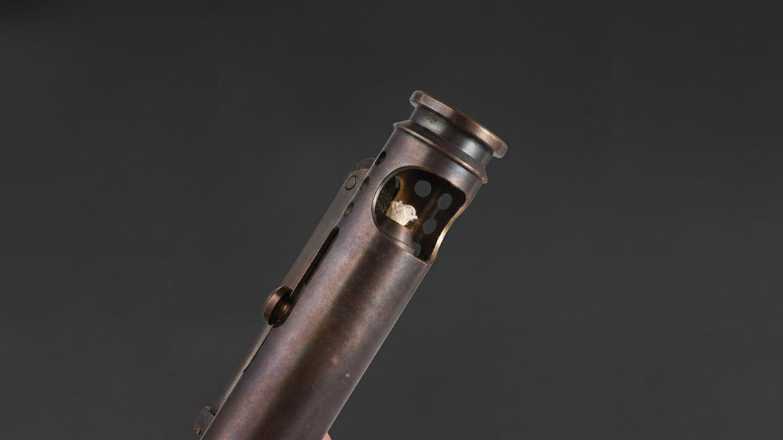 Antique brass trench lighter showing compact mechanical design and exposed wick structure