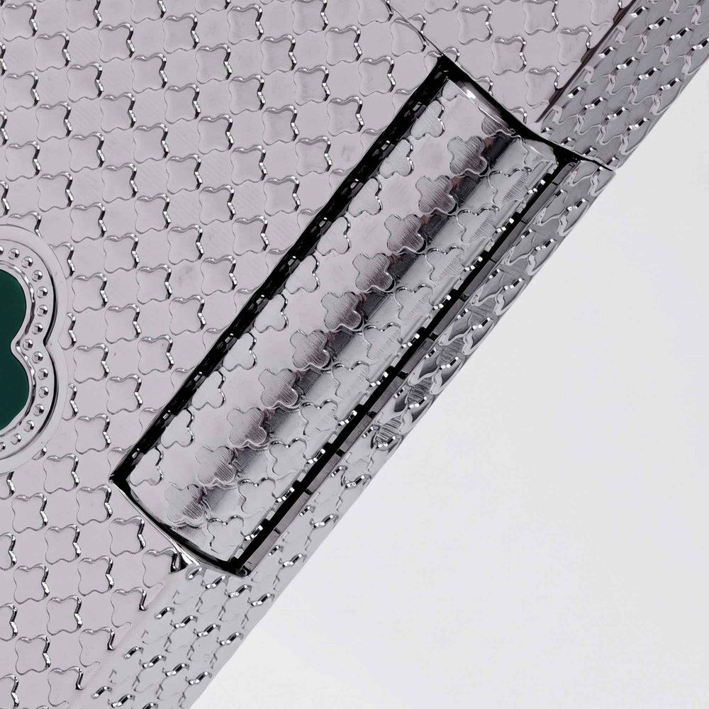 THORENS Clover Monogram Silver – Emerald Clover lighter featuring a precision-engraved clover pattern and a tactile mechanical hinge.