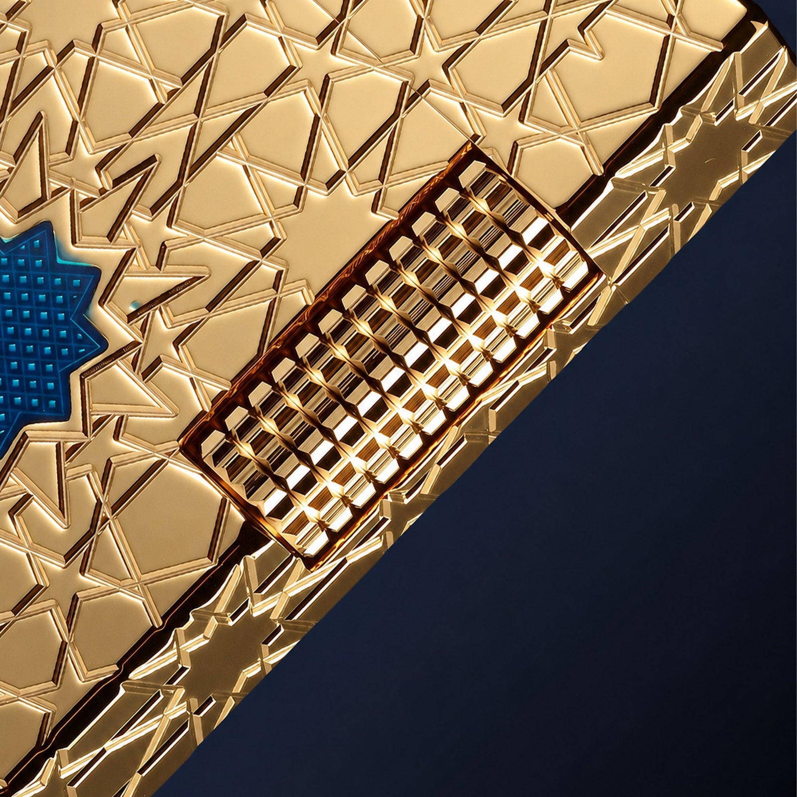 THORENS Stellar Mesh - Gold lighter featuring precision-engineered geometric star patterns and a tactile, knurled mechanical ignition slide.