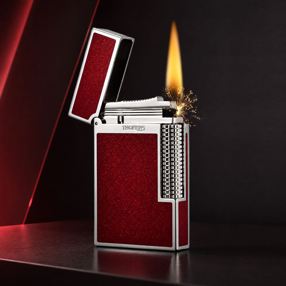 Thorens Scarlet Stardust fluid lighter with a red glitter finish, featuring a precision-engineered mechanical ignition and open flame.