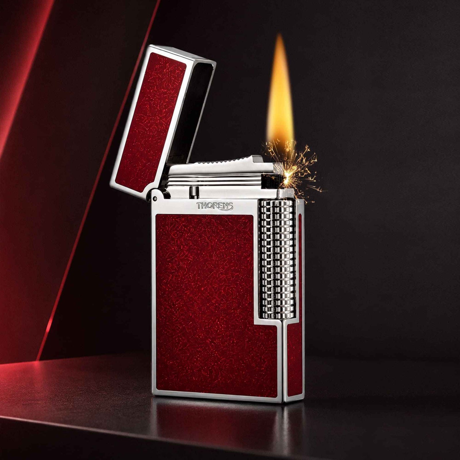 Thorens Scarlet Stardust fluid lighter with a red glitter finish, featuring a precision-engineered mechanical ignition and open flame.