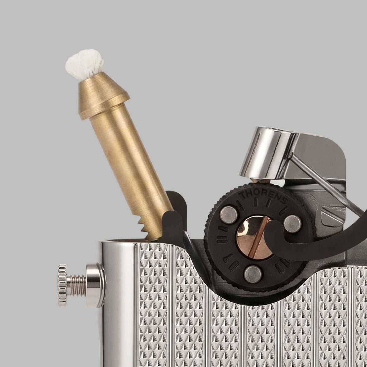THORENS Gen 7 Single Claw TELEFLAM Fluted Silver lighter with a precision-engineered telescopic arm lighting a wooden tobacco pipe.