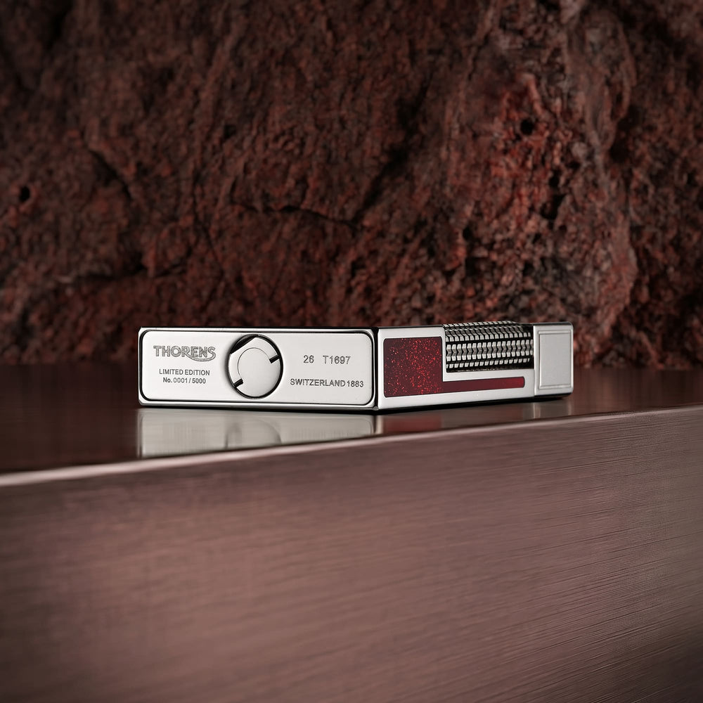 Limited edition Thorens Scarlet Stardust fluid lighter in polished steel with a red glitter inlay and precision-engraved base.