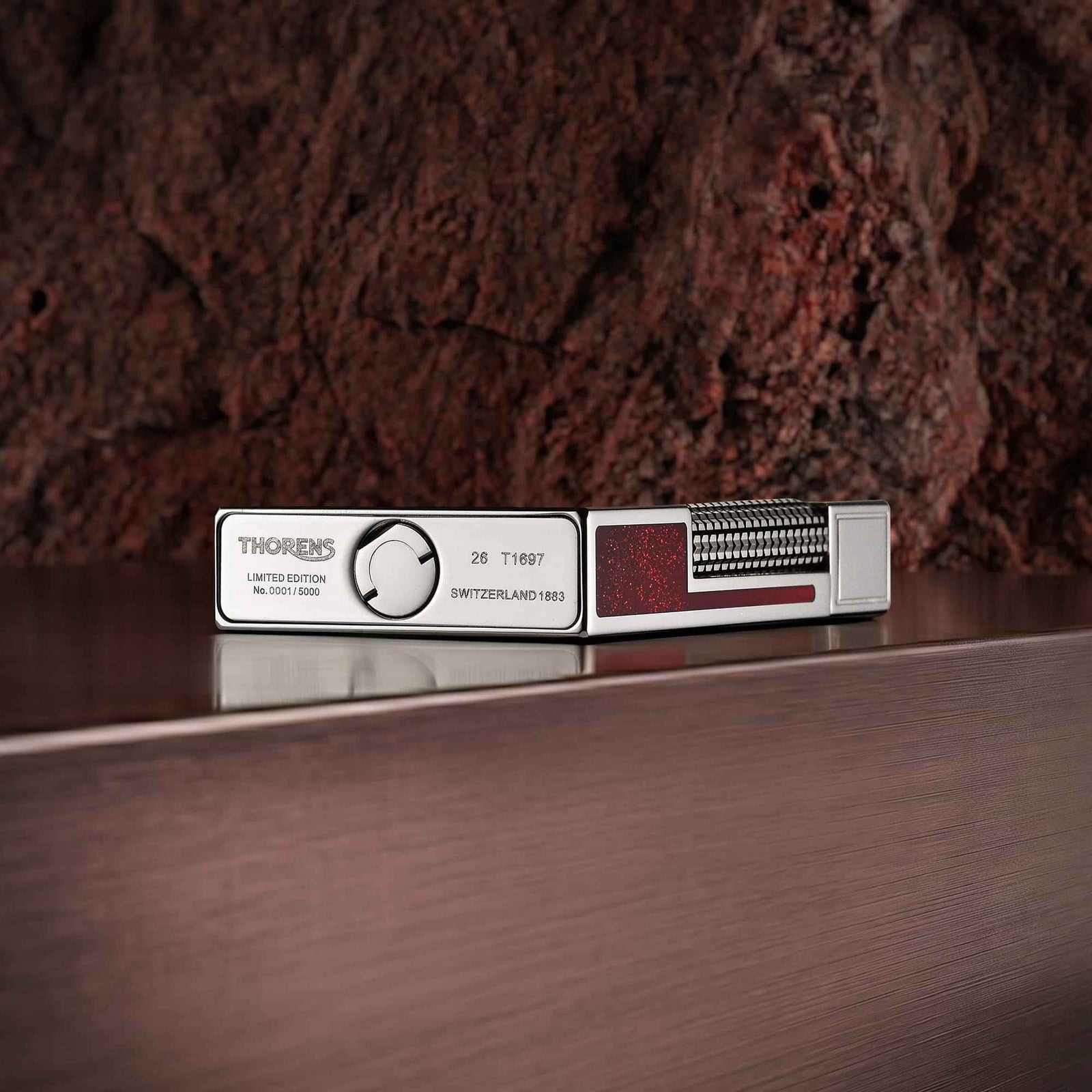 Limited edition Thorens Scarlet Stardust fluid lighter in polished steel with a red glitter inlay and precision-engraved base.