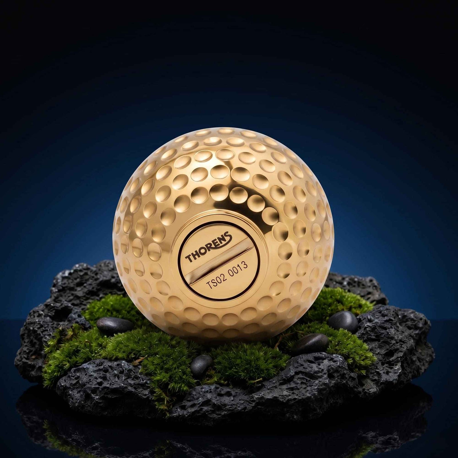 Thorens Dimpled Ace fluid lighter in solid brass with a golf ball texture, featuring a precision-engineered fuel cap and serial number.