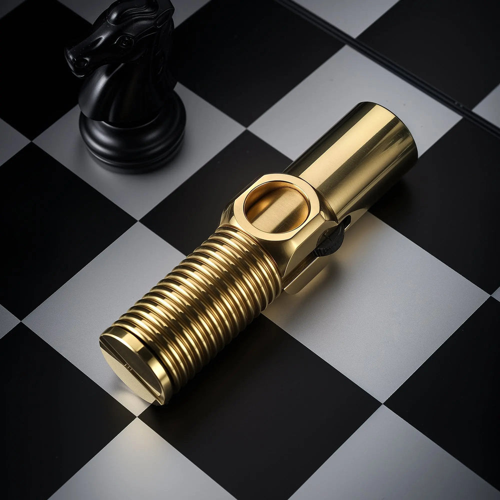 A heavy-duty brass Trench Lighter featuring a unique "Big Screw" threaded grip and side-mounted flint wheel, positioned next to a black knight on a silver and black chessboard.