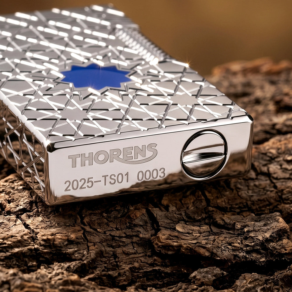 Detailed views of the Thorens Stellar Mesh Silver lighter, showcasing the precision-cut flint wheel, bottom hallmark engraving, and the vibrant blue mesh star inlay against a silver body.