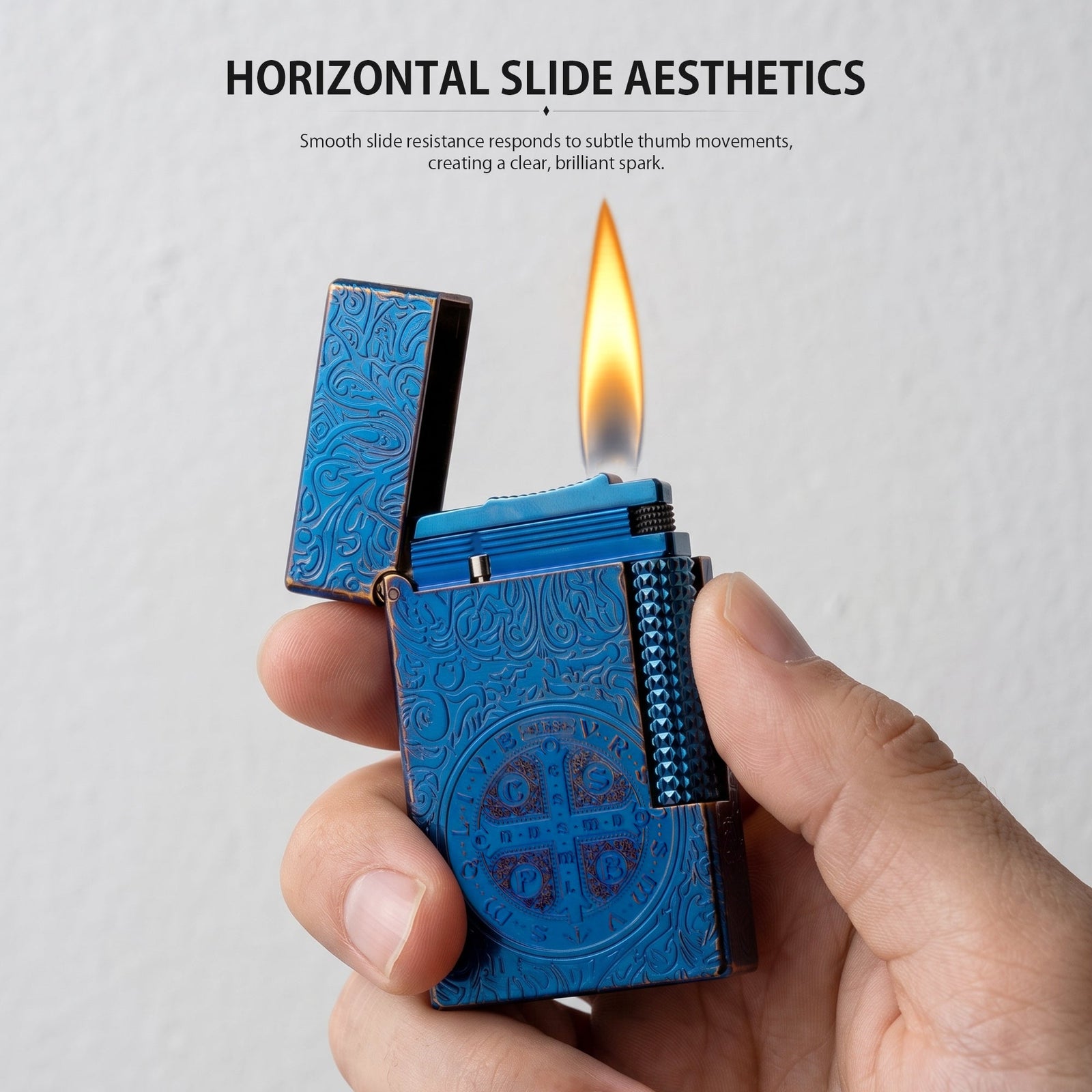 A lit Constantine Midnight Blue Sigil lighter showing a vibrant flame and sparks against a blue backdrop with textured stone elements.