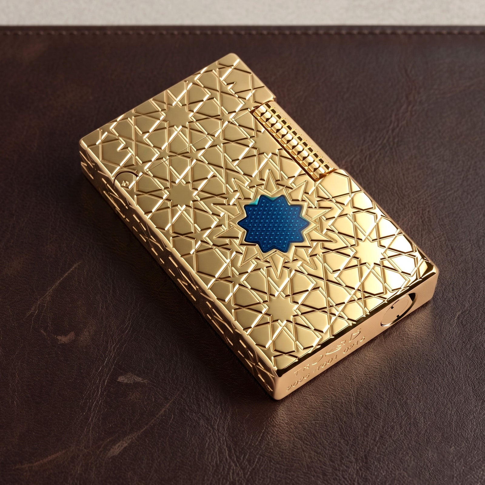 Close-up product details of the Stellar Mesh Gold lighter showcasing the textured flint wheel, deep-etched geometric star patterns, and signature blue mesh inlay.
