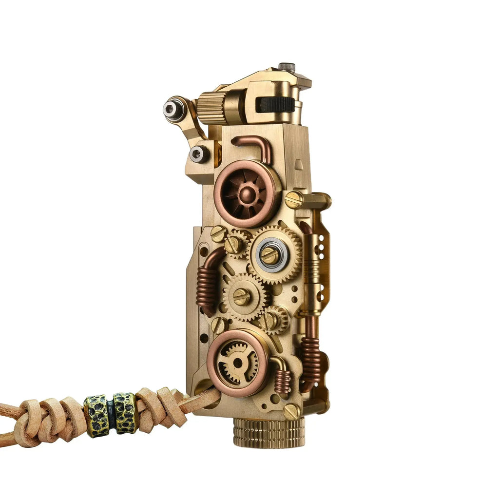 Front view of the Thorens steampunk mechanical grip lighter in brass finish on a white background, highlighting exposed fine gears, layered brass detailing, and a leather lanyard with bead accents