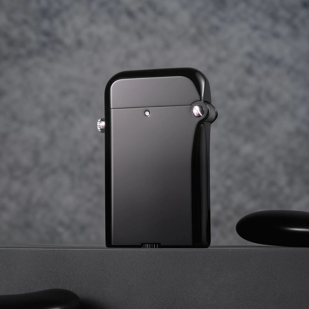 A Gen 4 Double Claw lighter featuring a sleek glossy black finish and mechanical side button, displayed on a textured gray surface.