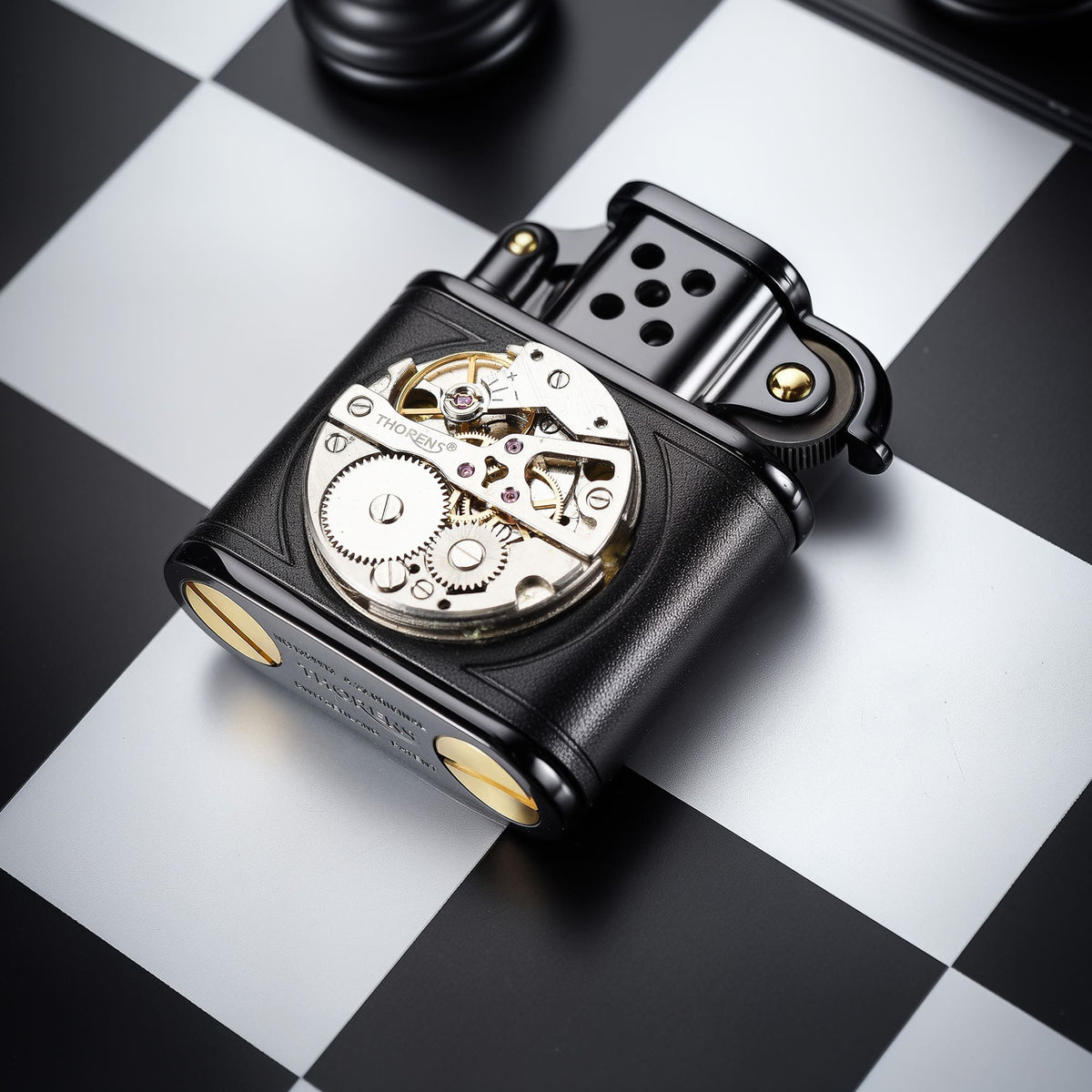Angled close-up of the hand-stitched black leather lighter with inlaid mechanical movement, highlighting the exposed movement window and bottom screw details.