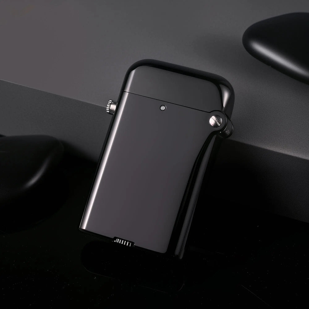 A Gen 4 Double Claw lighter resting at an angle, showcasing its glossy black finish and bottom fill wheel against a minimalist dark backdrop.