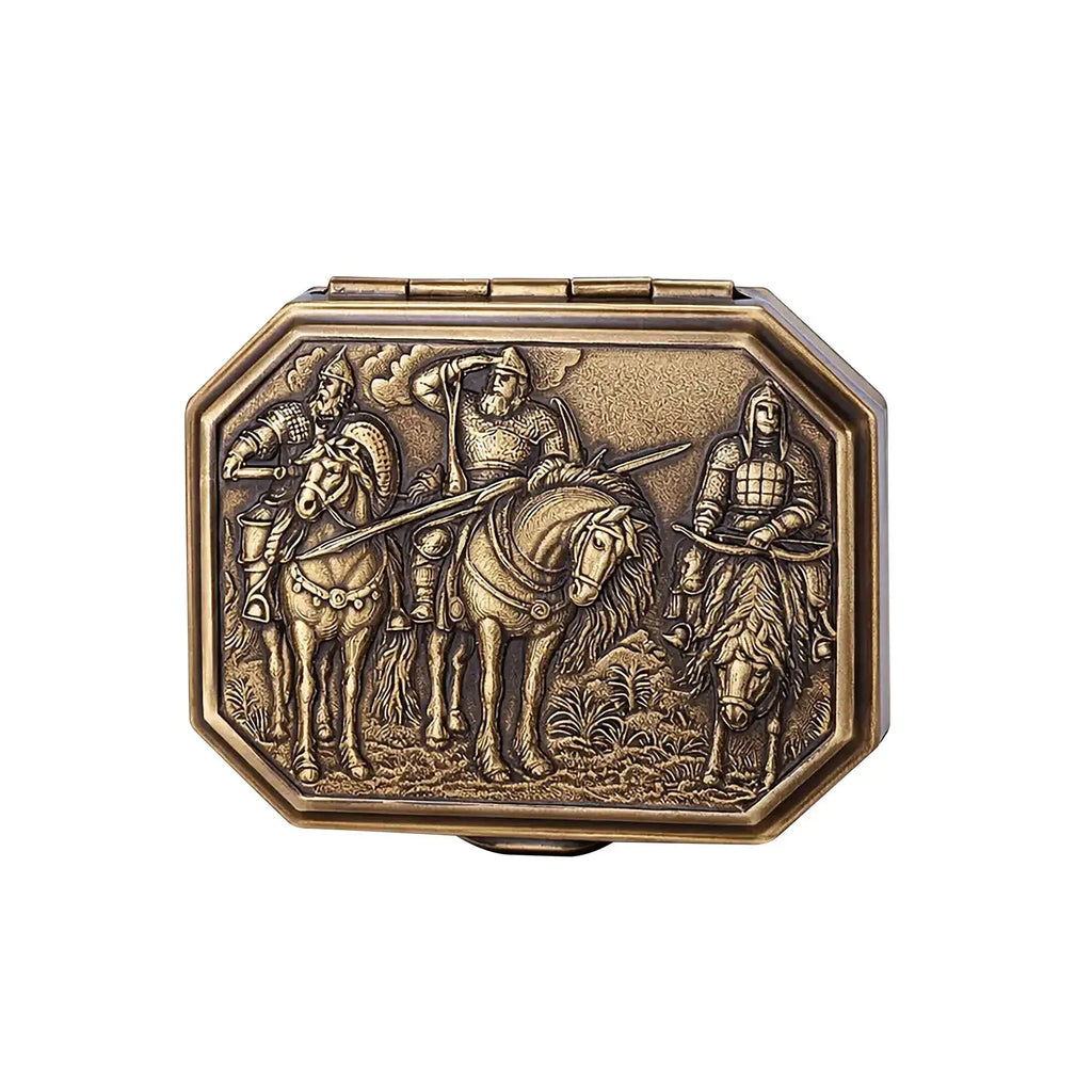 Front view of the Thorens Knight’s Era matchbox lighter on a white background, featuring an engraved medieval rider scene and antique brass finish with heritage-inspired detail