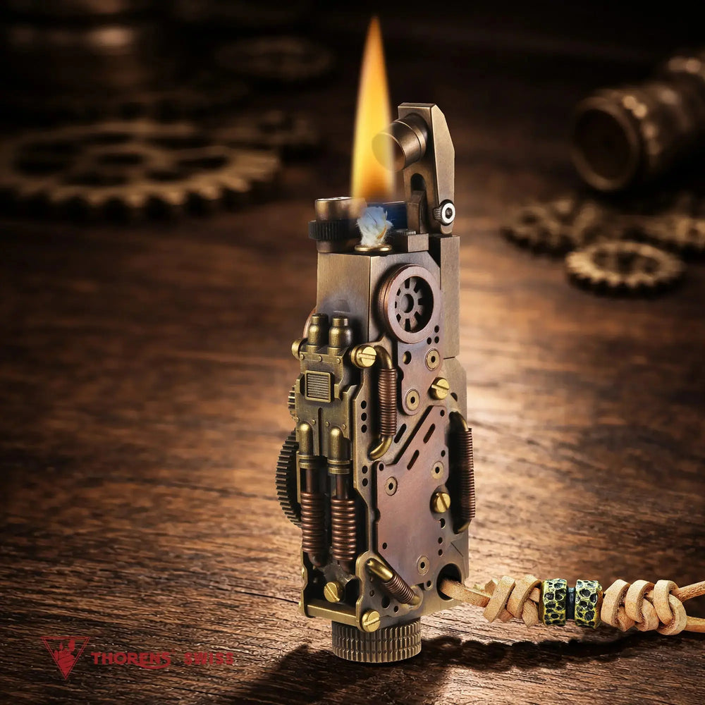 Thorens steampunk mechanical grip grand gear lighter in antique bronze shown lit on a warm wood surface, featuring oversized mechanical detailing, mixed metal tones, and a leather lanyard with bead accents