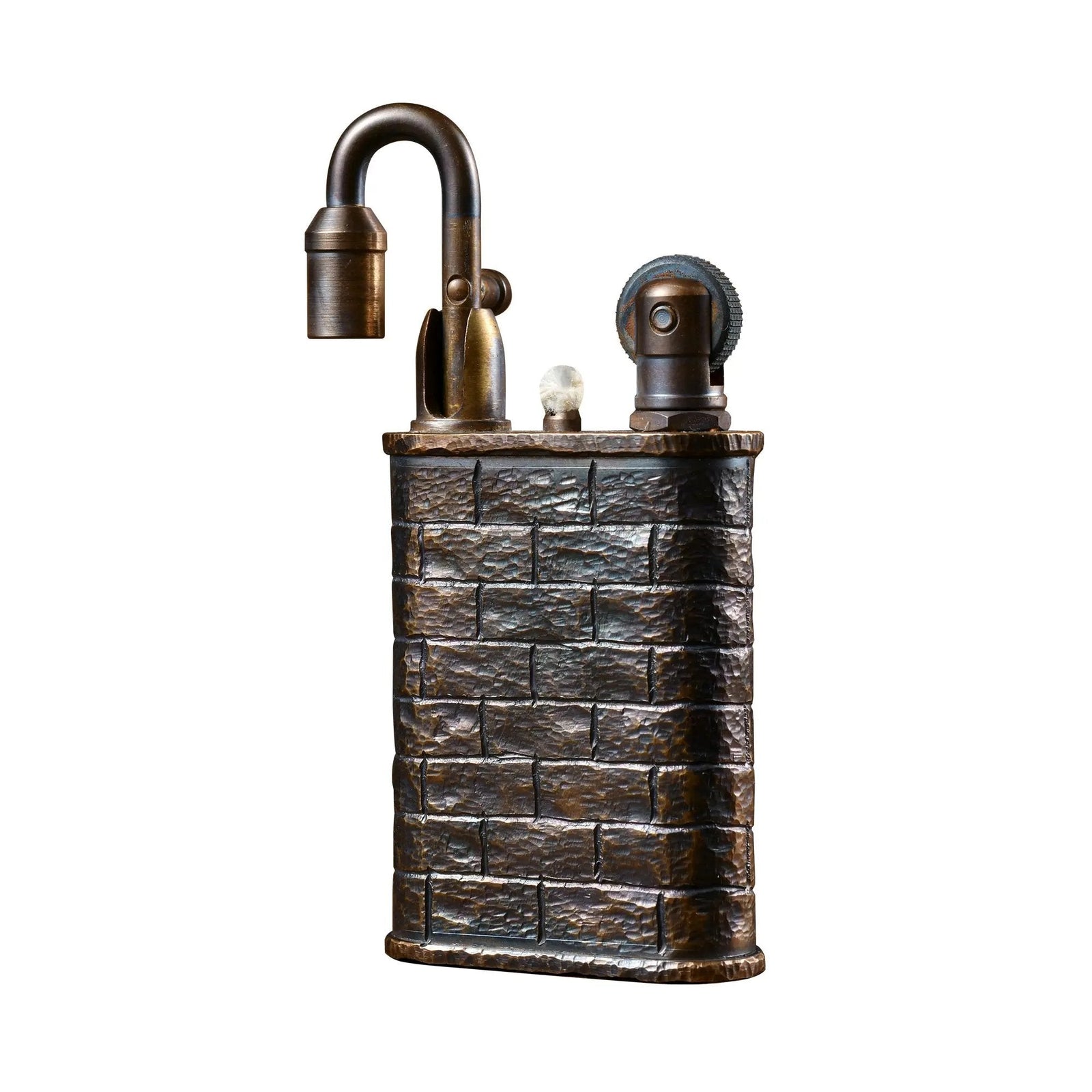A studio shot of the Thorens Lockflame lighter against a white background, highlighting the hand-carved brick wall texture and weathered brass finish.