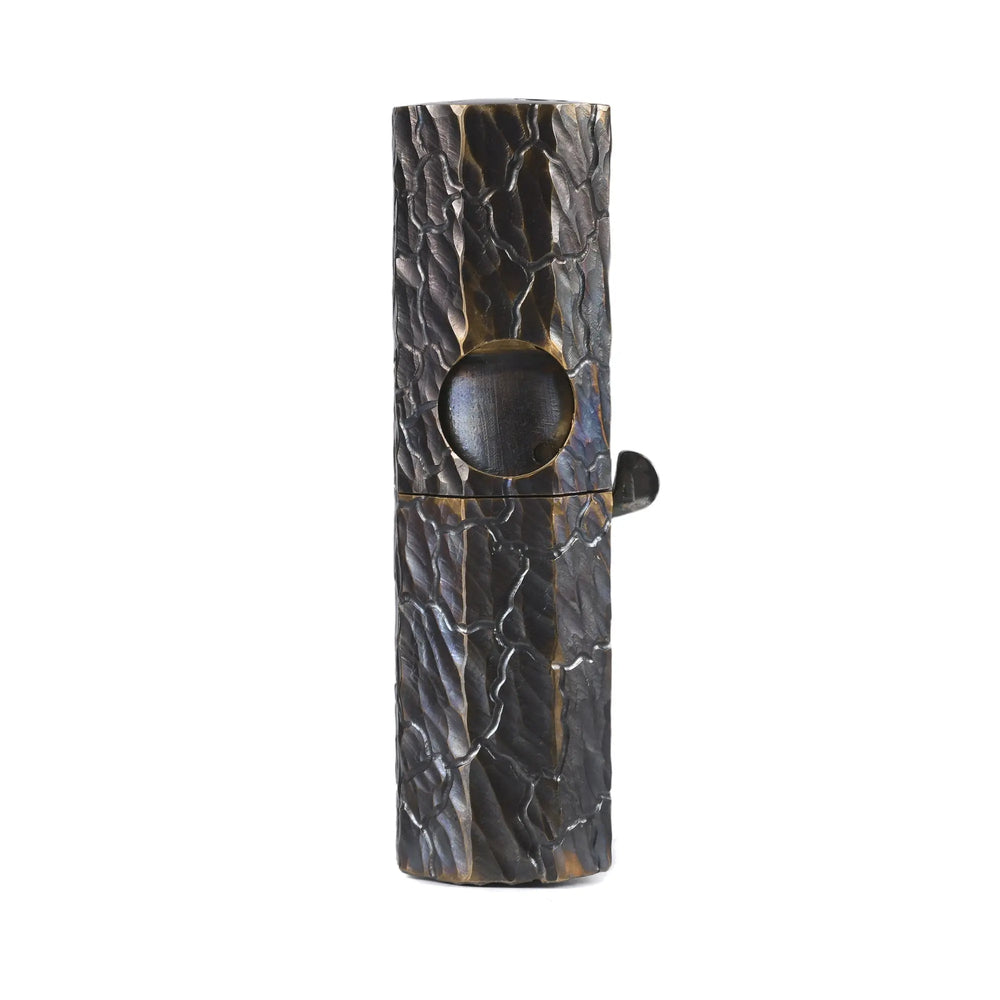 A sleek Octagon Trigger mechanical lighter featuring a glossy black hand-carved texture and antique brass accents, showcasing refined EDC aesthetics and heritage craftsmanship.