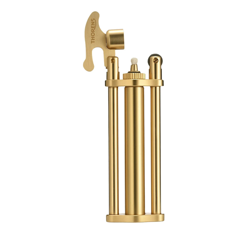 A studio shot of the Three-Section Stick Lighter in a brushed brass finish with the cap open, revealing the wick and flint wheel assembly on a clean white background.