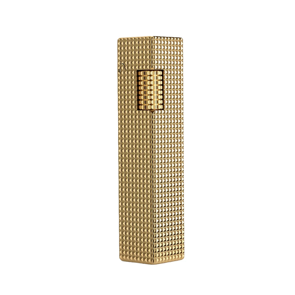 A slender rectangular Side Slip lighter in a brilliant gold finish, featuring an all-over small square "diamond head" textured pattern and a matching knurled ignition roller.
