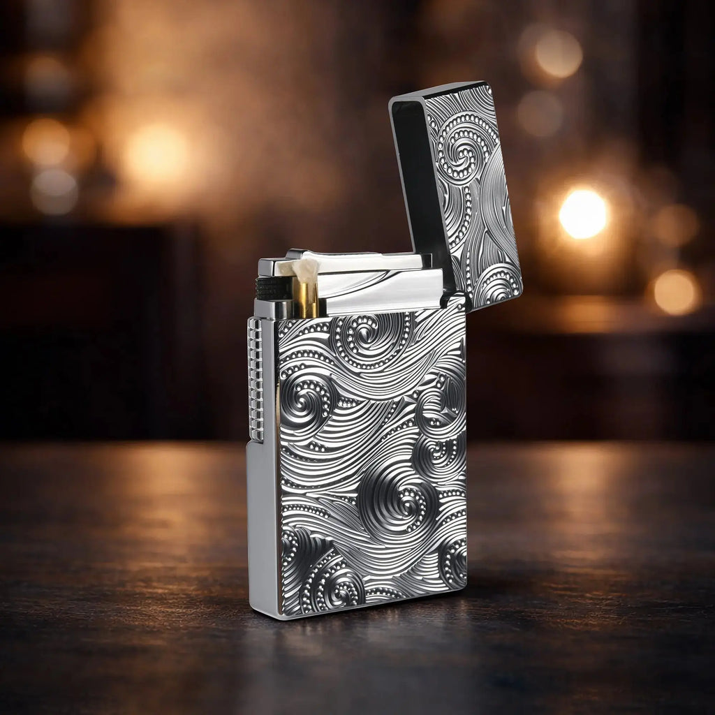 A cinematic shot of an open "Side Slip" lighter in a brilliant silver finish, featuring deep-carved vortex and swirl engravings. The image highlights the polished brass wick holder, the textured side-slip roller, and the high-luster interior of the flip-top lid.