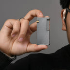 Thorens Slim Cube Silver Mesh lighter held in hand, showing its slim rectangular form, silver mesh finish, polished silver-tone edges, and gold-tone accent against a neutral background