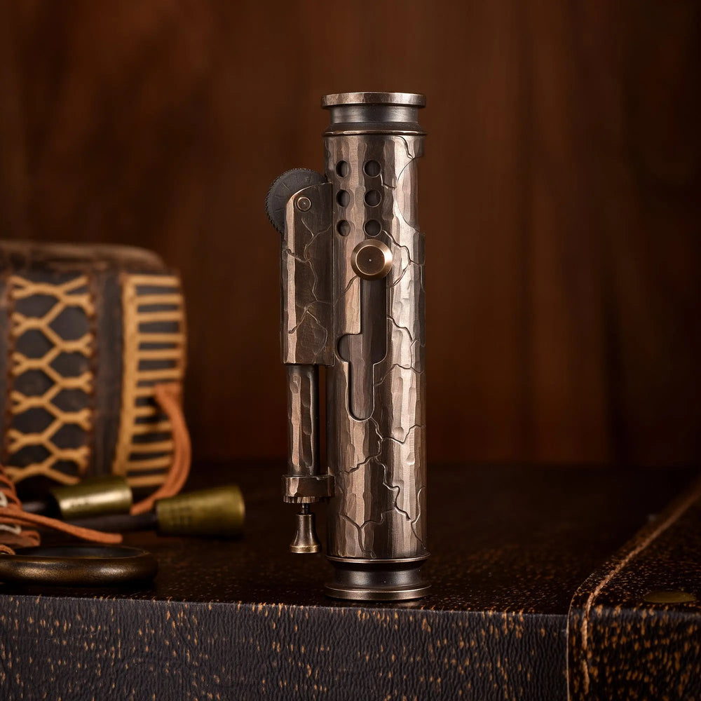 A vertical shot of the Battle Soul trench lighter standing upright, featuring hand-carved cracks on a weathered brass body with a sliding windguard.