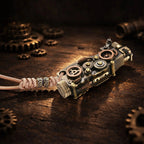 Thorens steampunk mechanical grip lighter in antique bronze resting on a dark wood surface, showcasing exposed fine gear detailing, layered metal construction, and a leather lanyard with decorative bead accents